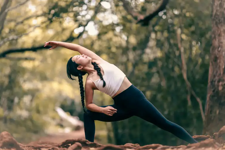 A woman stretching outdoors as part of an everyday preventive health routine