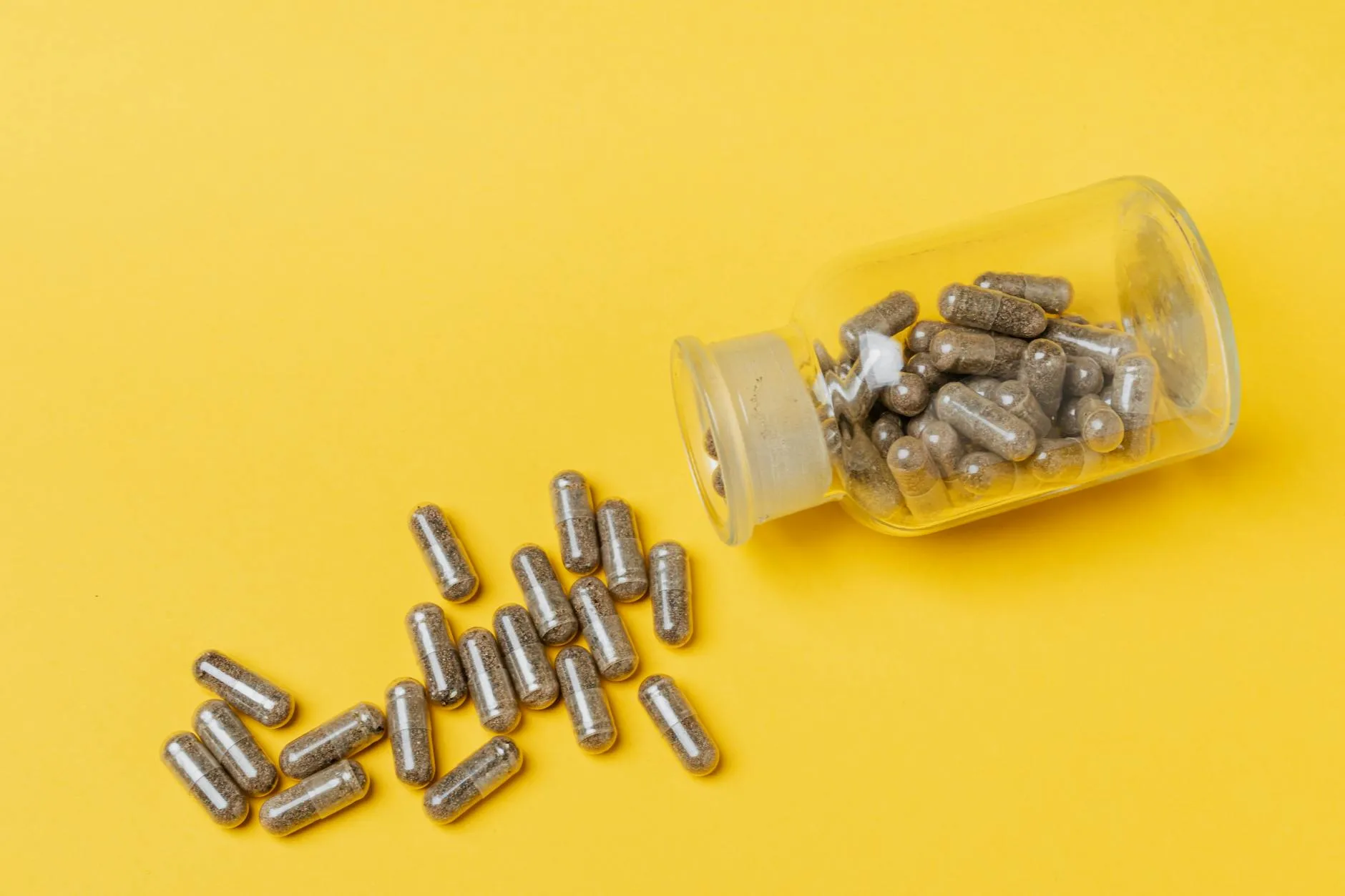 Magnesium glycinate capsules in an open bottle