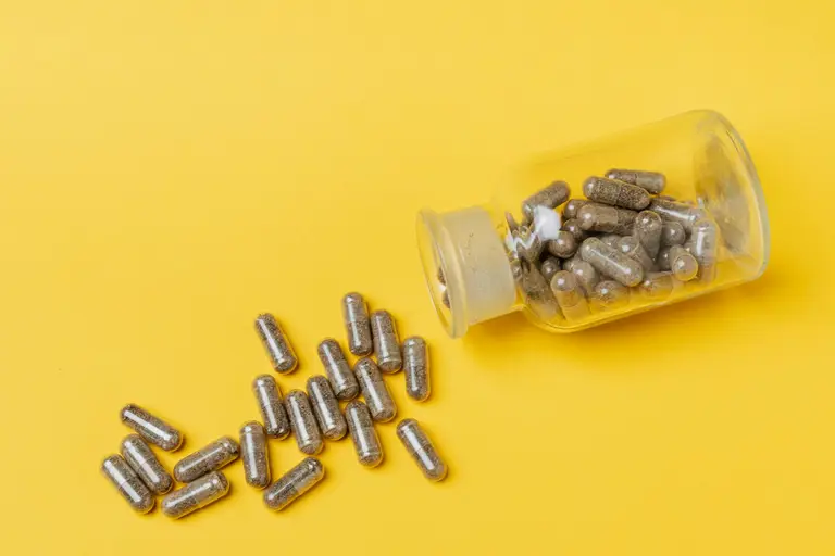 Magnesium glycinate capsules in an open bottle