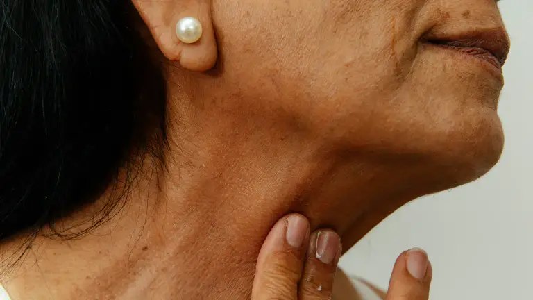 A person checking the pulse at their neck