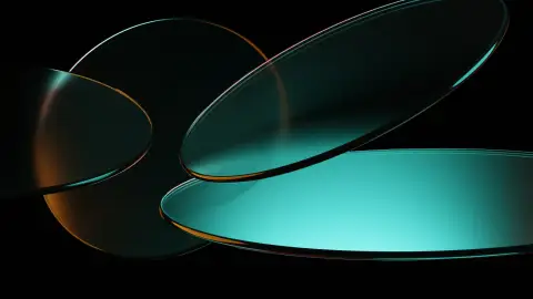Abstract teal and amber glass discs on a dark background