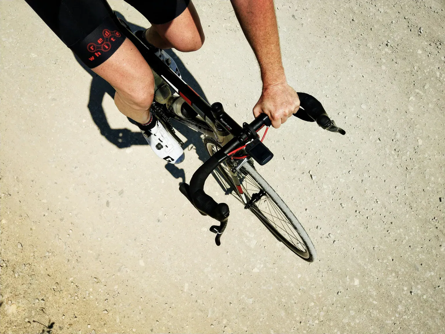 An overhead view of a cyclist riding a road bike