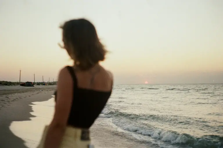 Woman standing on a beach in daylight