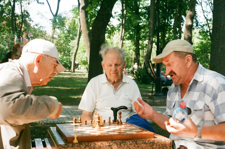 Two people playing chess across a table