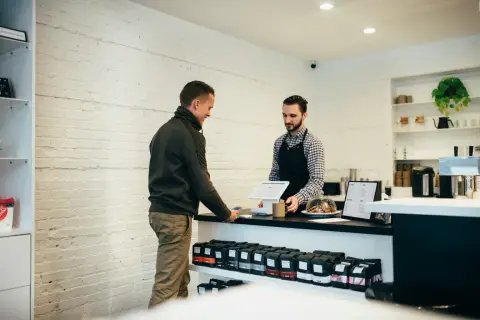 Person paying for something at a shop counter
