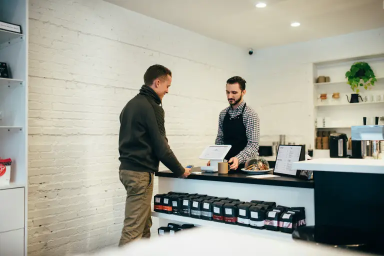 Person paying for something at a shop counter
