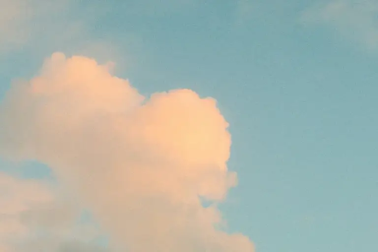 Warm clouds in a pale blue sky