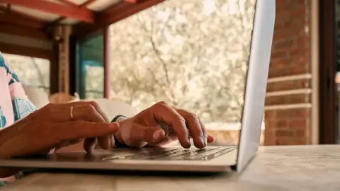 Person using a laptop to search for nearby lab testing locations