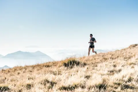 A runner moving across a mountain trail