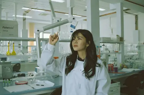 Woman in a white lab coat standing in a laboratory